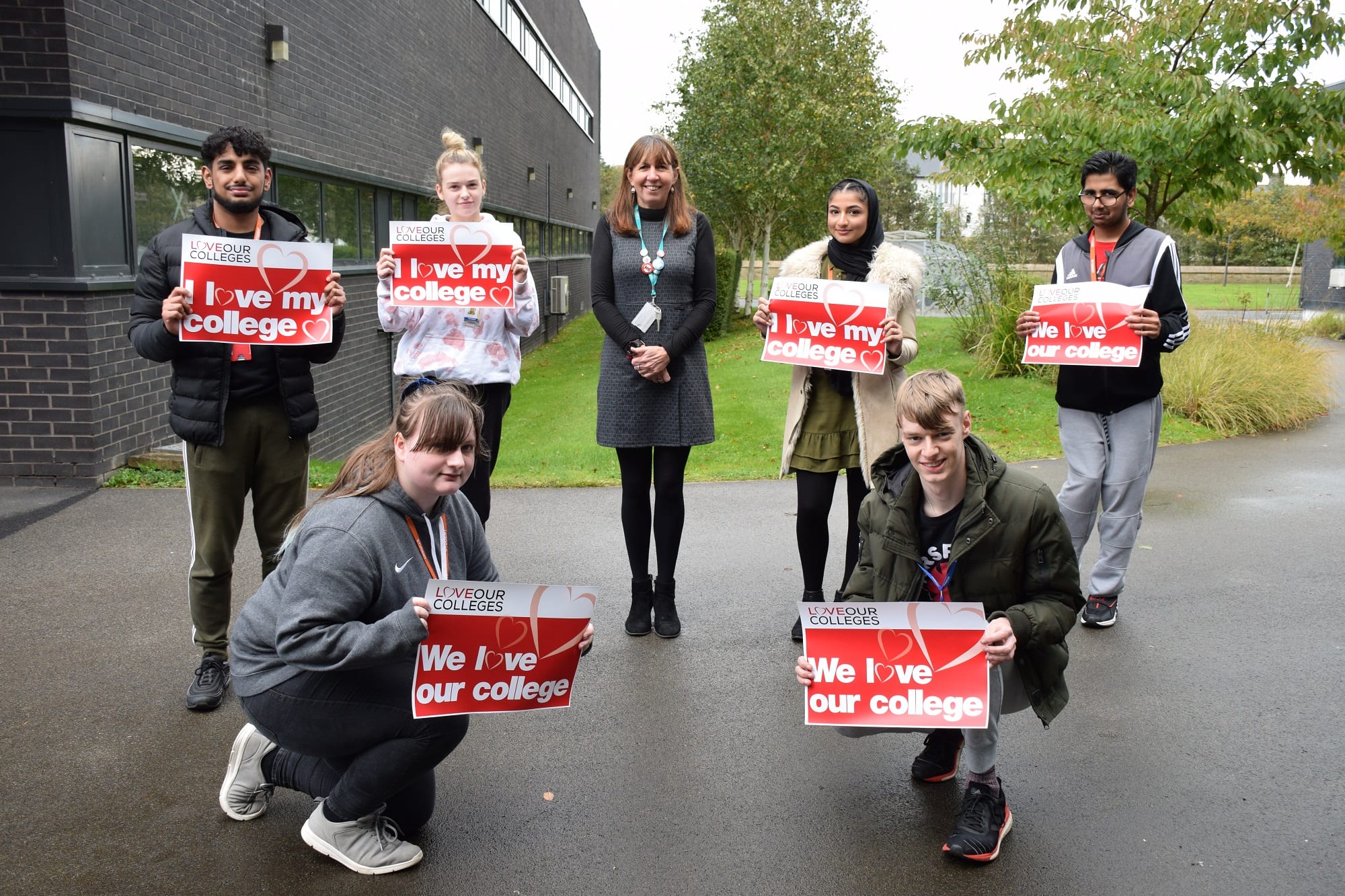 College's week photo, students with 'Love our College's signs